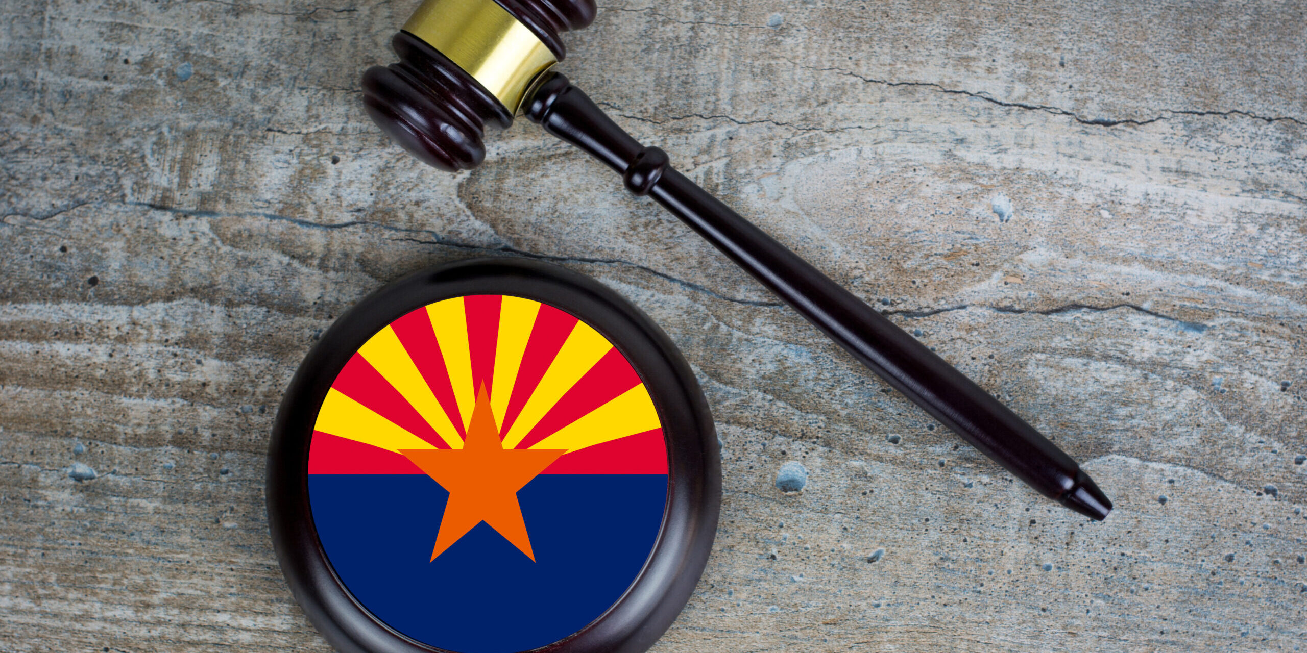 Wooden judgement or auction mallet with of Arizona flag. Conceptual image.